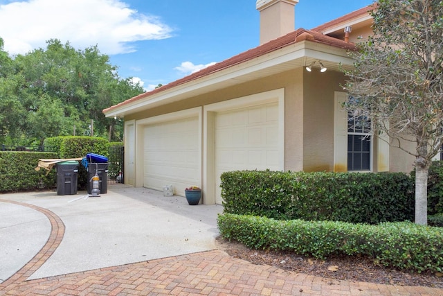 garage with decorative driveway