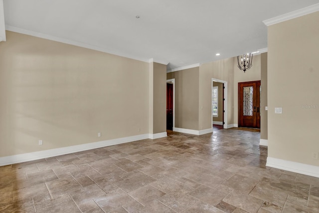 foyer entrance featuring a chandelier, crown molding, and baseboards