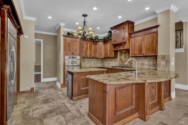 kitchen with a peninsula, stainless steel fridge, brown cabinetry, and a sink