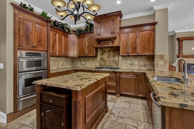 kitchen with ornamental molding, stainless steel appliances, stone tile flooring, a sink, and a warming drawer