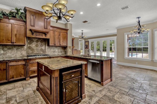 kitchen featuring a chandelier, a sink, visible vents, stainless steel dishwasher, and stone tile flooring