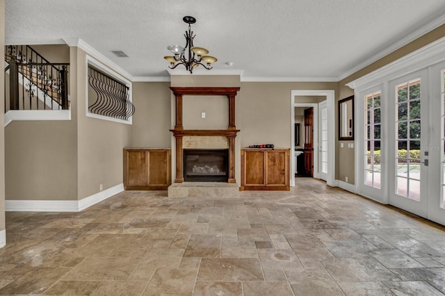 unfurnished living room with visible vents, stairway, ornamental molding, a glass covered fireplace, and baseboards