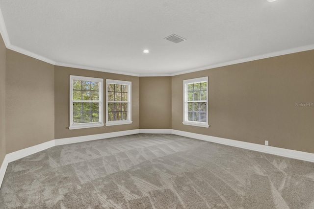 unfurnished room featuring visible vents, baseboards, carpet flooring, and ornamental molding