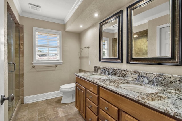 bathroom with ornamental molding, a sink, visible vents, and baseboards