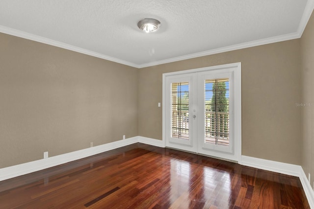 unfurnished room featuring baseboards, ornamental molding, wood finished floors, a textured ceiling, and french doors