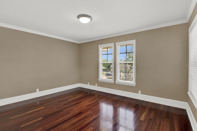 unfurnished room with ornamental molding, dark wood-type flooring, a textured ceiling, and baseboards