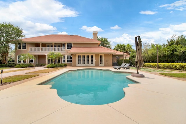 outdoor pool featuring french doors and a patio