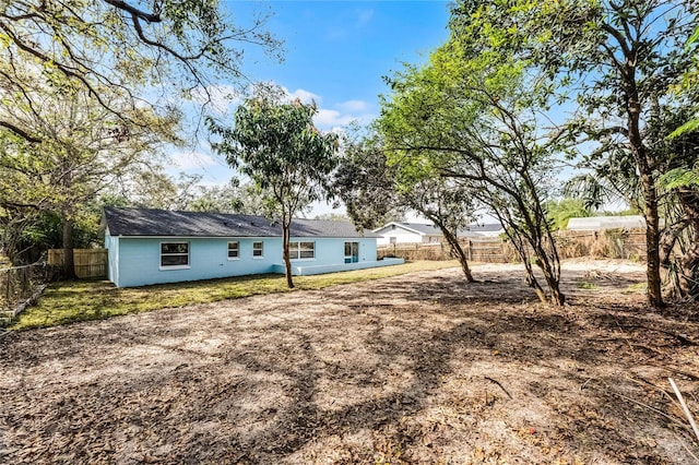 exterior space with a fenced backyard and concrete block siding