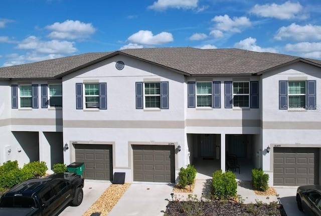 view of front of house featuring a garage, driveway, and stucco siding