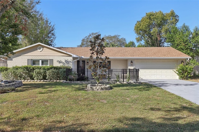 ranch-style home featuring a garage, a front yard, concrete driveway, and brick siding