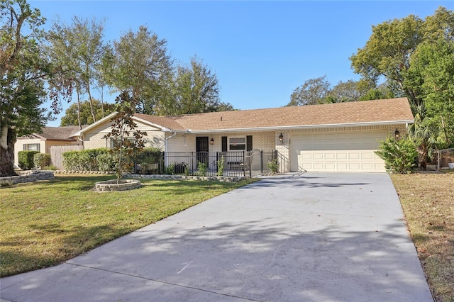 ranch-style home featuring a garage, brick siding, fence, concrete driveway, and a front yard