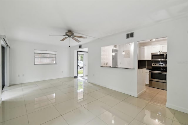 unfurnished living room with a ceiling fan, visible vents, baseboards, and light tile patterned floors