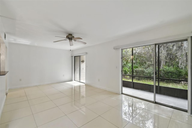 spare room featuring light tile patterned floors, baseboards, and a ceiling fan