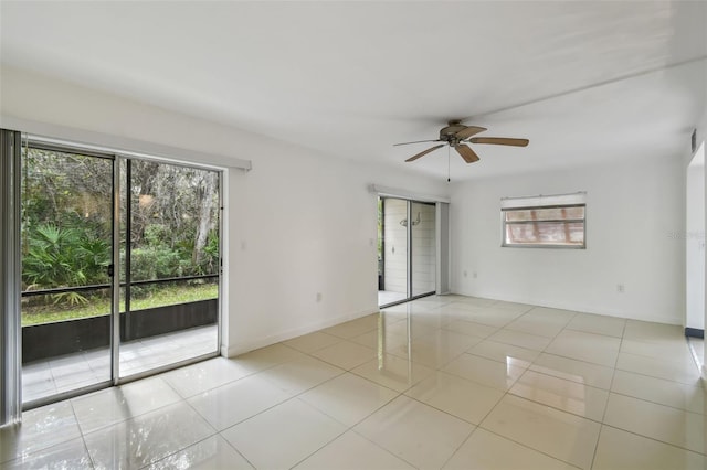 tiled empty room with a ceiling fan