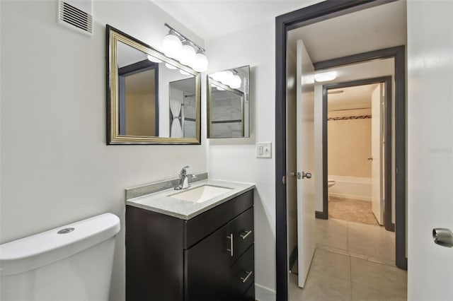 bathroom with toilet, tile patterned flooring, vanity, and visible vents