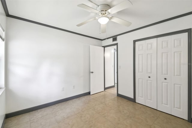 unfurnished bedroom with crown molding, a closet, visible vents, ceiling fan, and baseboards
