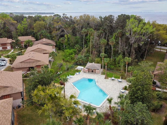 drone / aerial view with a water view and a view of trees