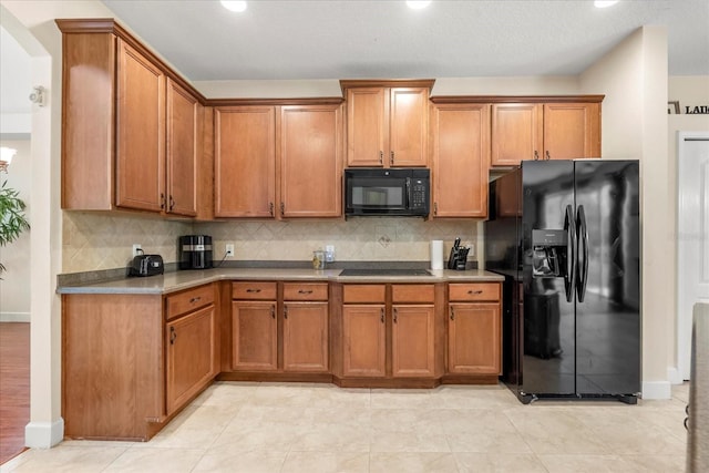 kitchen with brown cabinets, backsplash, and black appliances