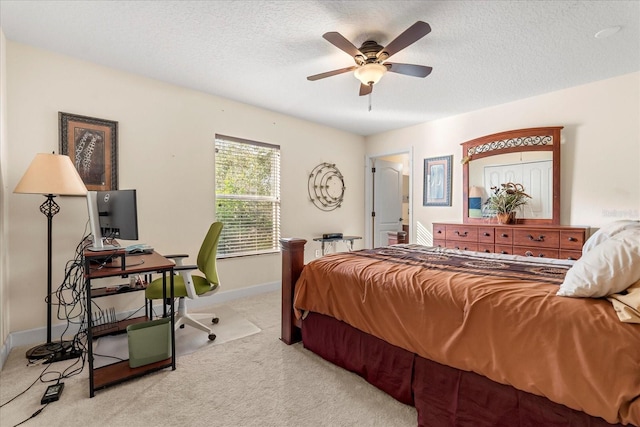 bedroom featuring carpet floors, ceiling fan, baseboards, and a textured ceiling