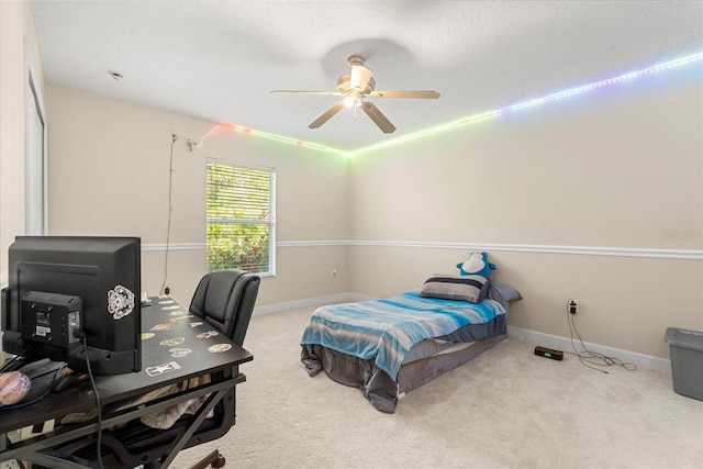 bedroom featuring carpet floors, a ceiling fan, and baseboards