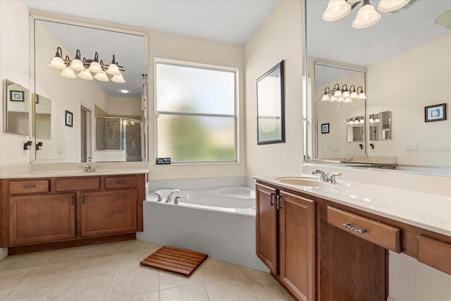 bathroom with a garden tub, a shower stall, a sink, and tile patterned floors