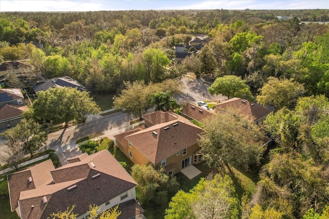 aerial view featuring a residential view and a wooded view