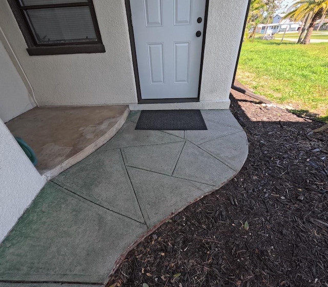 entrance to property with stucco siding