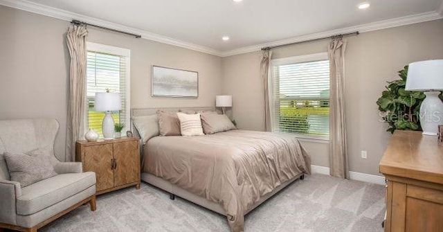 bedroom featuring light carpet, baseboards, and crown molding