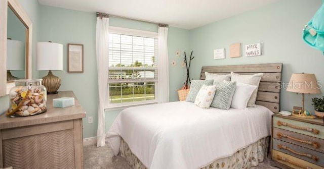 bedroom featuring carpet floors and baseboards