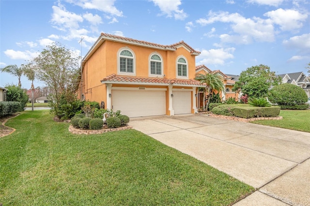 mediterranean / spanish-style house with an attached garage, a tile roof, driveway, stucco siding, and a front lawn