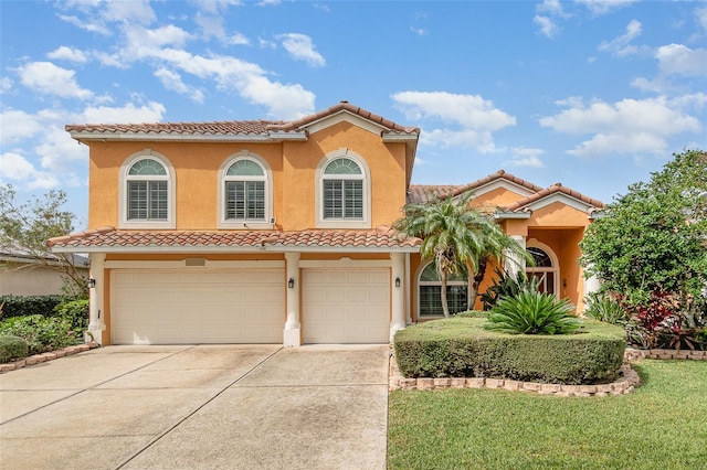 mediterranean / spanish-style house featuring a garage, driveway, a tiled roof, and stucco siding