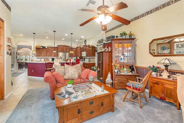 living room featuring arched walkways, light tile patterned floors, recessed lighting, visible vents, and a ceiling fan