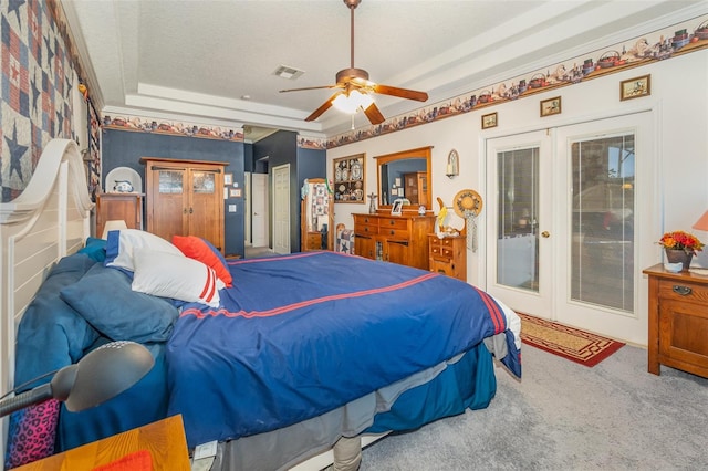 carpeted bedroom featuring visible vents, a ceiling fan, access to outside, french doors, and a tray ceiling