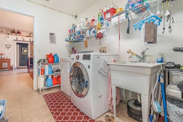 laundry room featuring laundry area, tile patterned flooring, and washer and clothes dryer