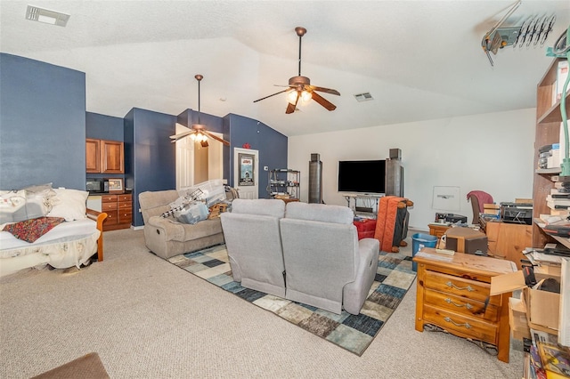 living area with visible vents, vaulted ceiling, and light carpet