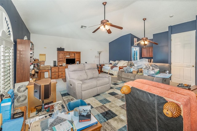 living room with lofted ceiling, visible vents, and a ceiling fan