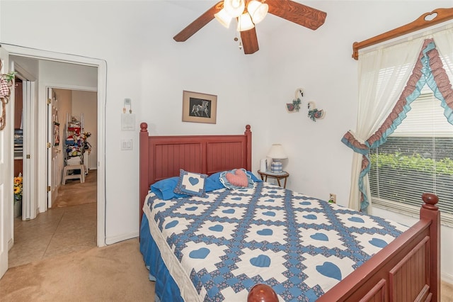 bedroom featuring light carpet, ceiling fan, and light tile patterned flooring