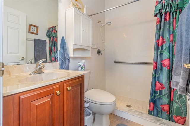 full bathroom with toilet, a tile shower, and vanity