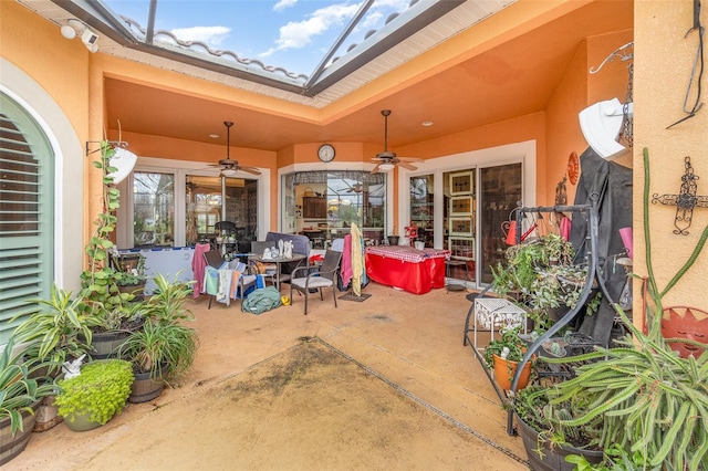 view of patio featuring a lanai and ceiling fan