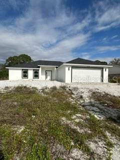 ranch-style house featuring an outbuilding and an attached garage