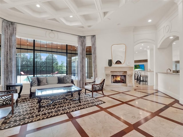 living area with coffered ceiling, recessed lighting, a fireplace, and baseboards