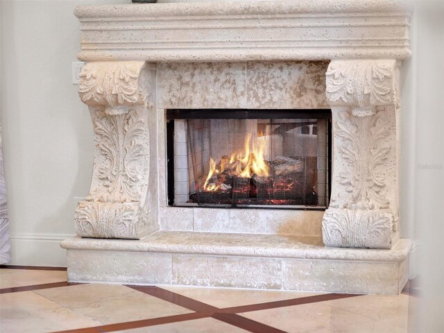 details with a lit fireplace and baseboards