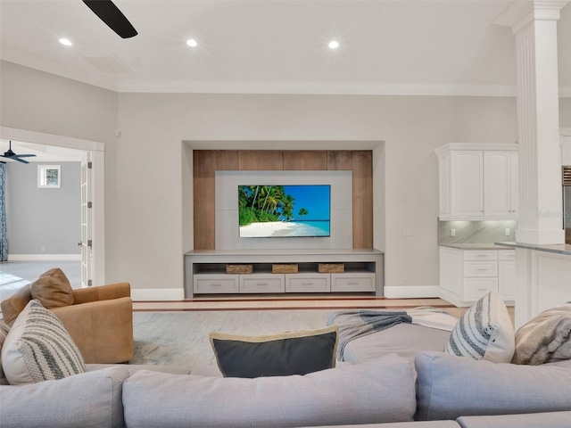 living room with baseboards, recessed lighting, a ceiling fan, and crown molding