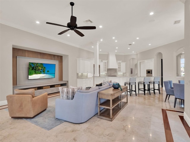 living room with marble finish floor, a ceiling fan, visible vents, and recessed lighting