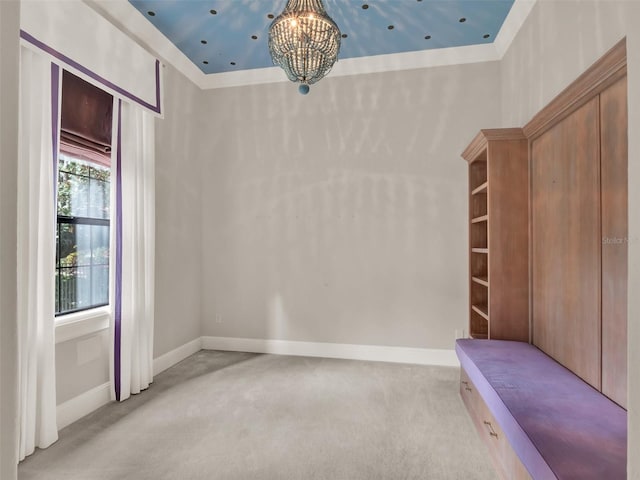 empty room featuring light carpet, a notable chandelier, and baseboards