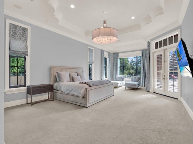 carpeted bedroom featuring baseboards, french doors, a tray ceiling, and access to exterior