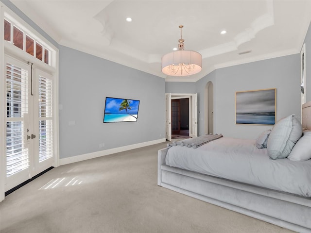 carpeted bedroom with baseboards, a raised ceiling, arched walkways, ornamental molding, and access to outside