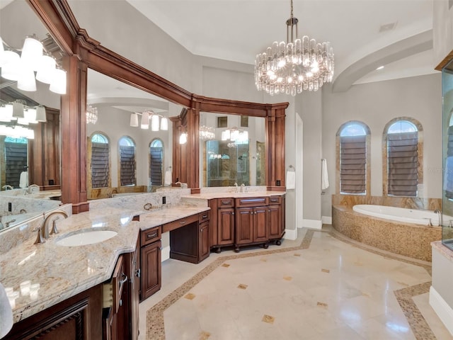 full bath with a chandelier, a garden tub, vanity, and baseboards