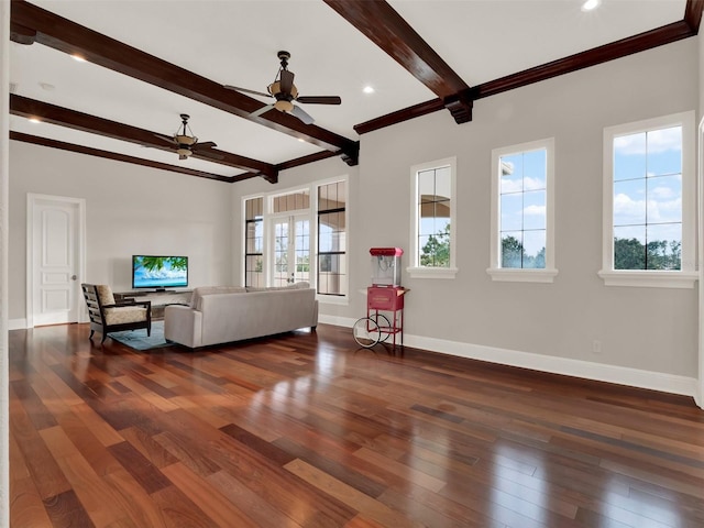 living area with a ceiling fan, beamed ceiling, hardwood / wood-style flooring, and baseboards