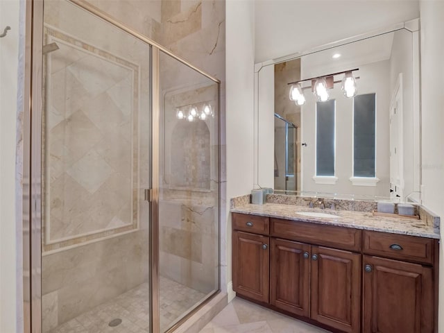 bathroom with tile patterned flooring, a shower stall, and vanity